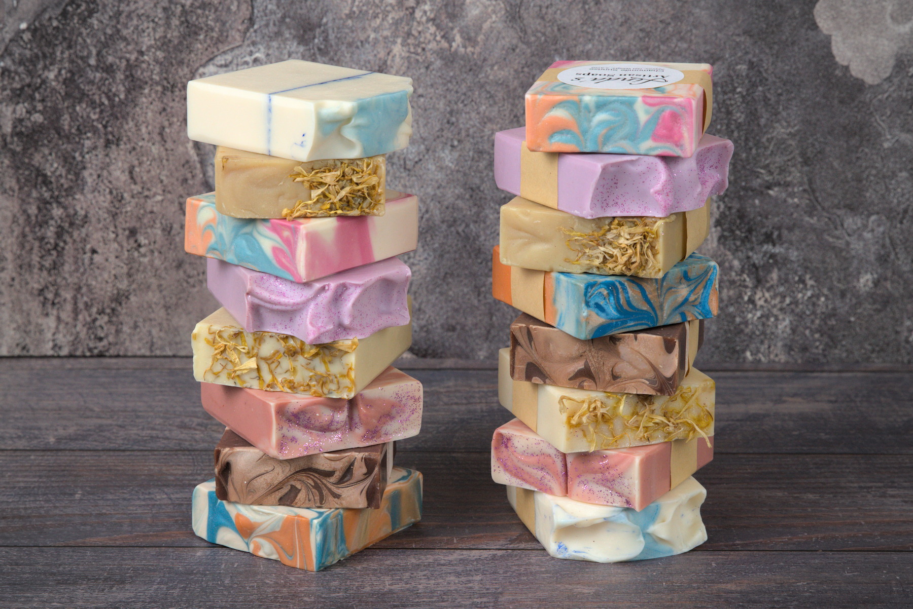 A dual vertical stack of artisan cold process soaps with the focus on the design of the soap tops.